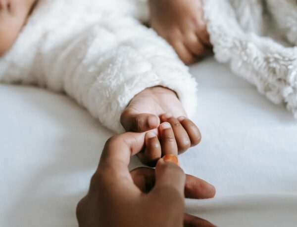 mother holding baby's hand