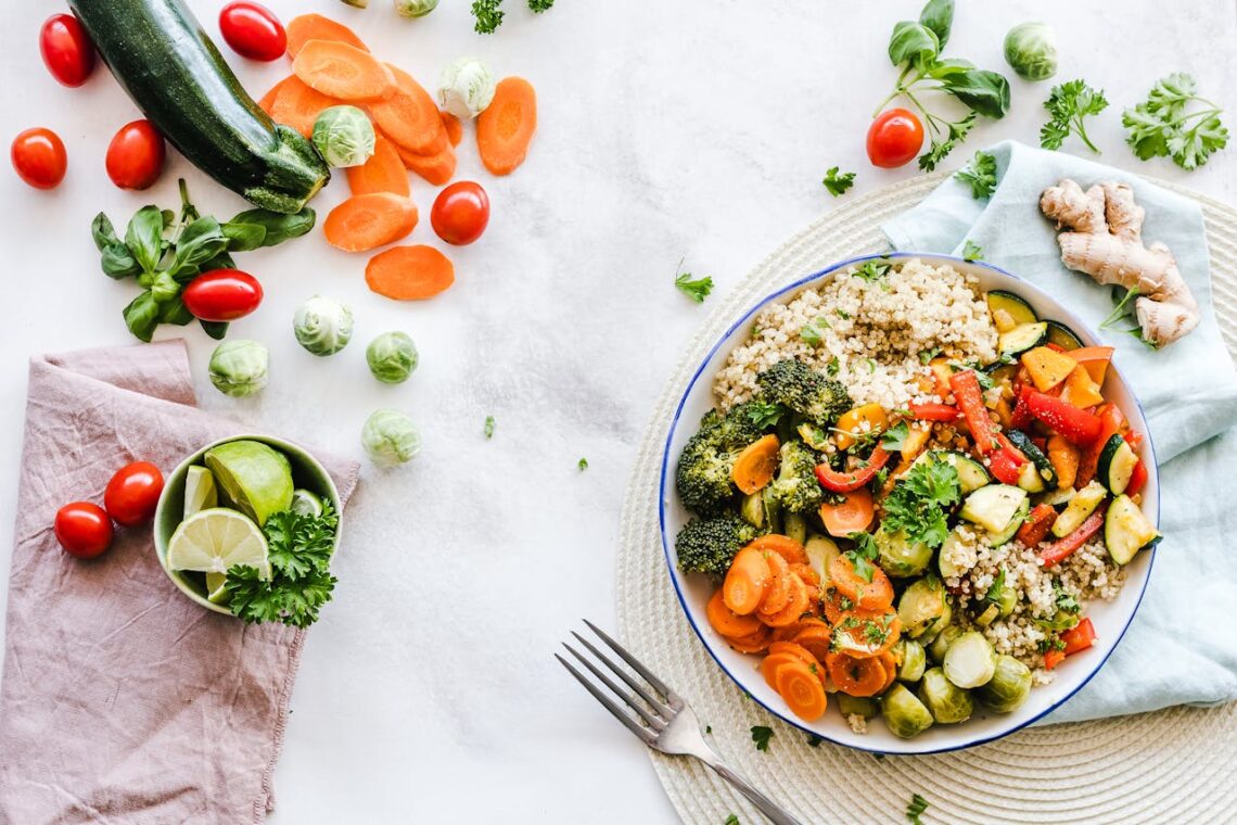 a plate of vegetables and quinoa on a set table