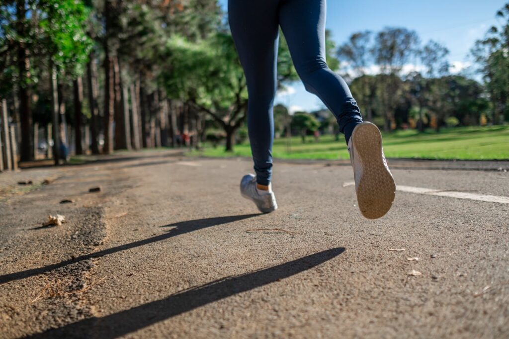 legs of a woman running in trainers