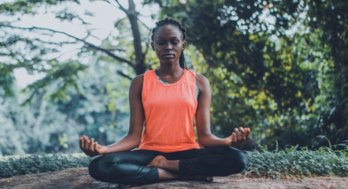 A lady meditating in the outdoors