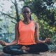 A lady meditating in the outdoors