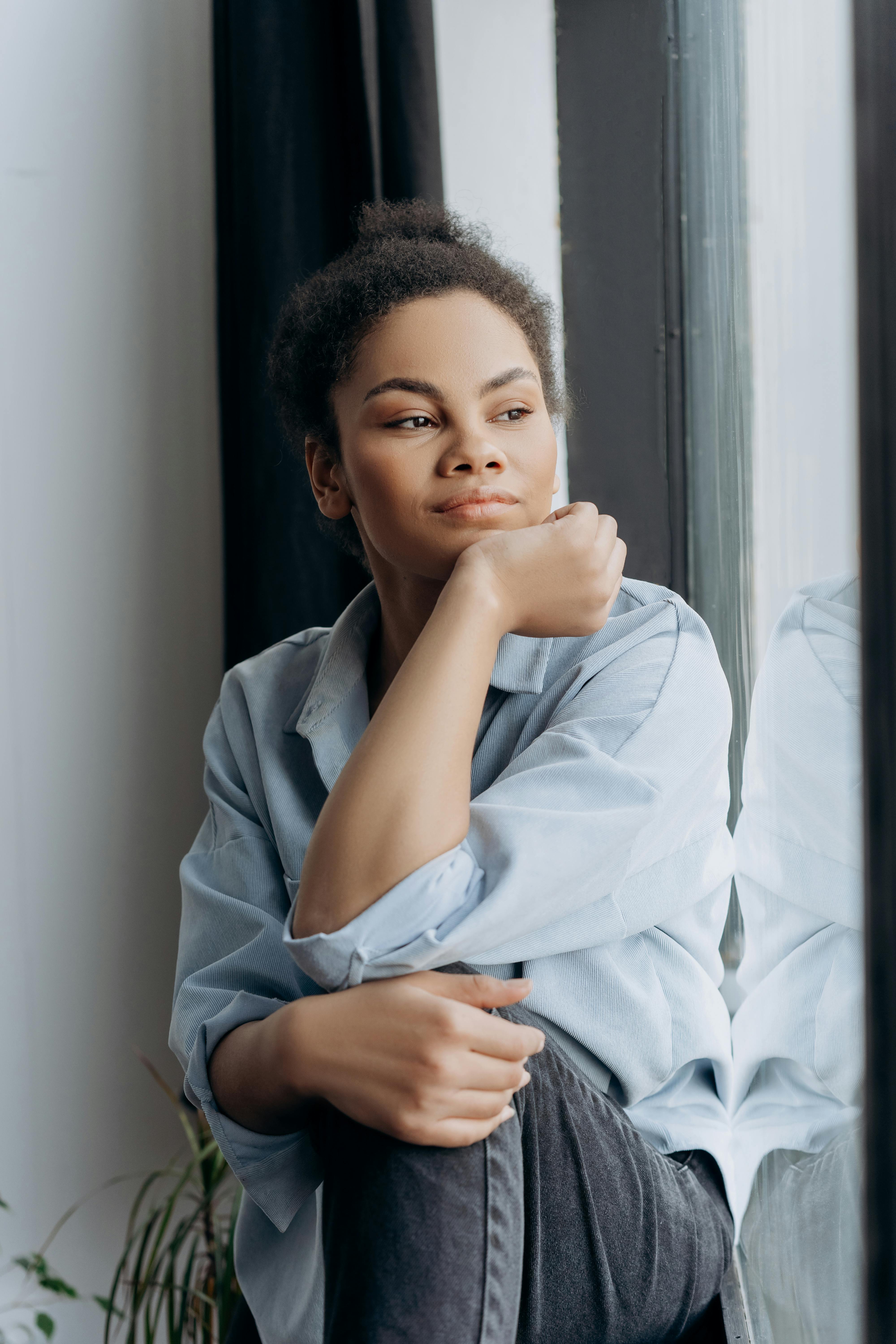 woman sitting down and looking out the window