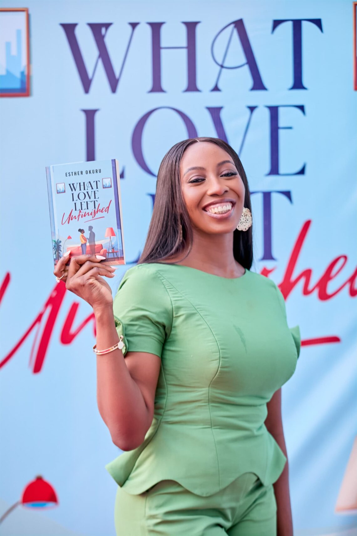 Woman smiling and holding a book