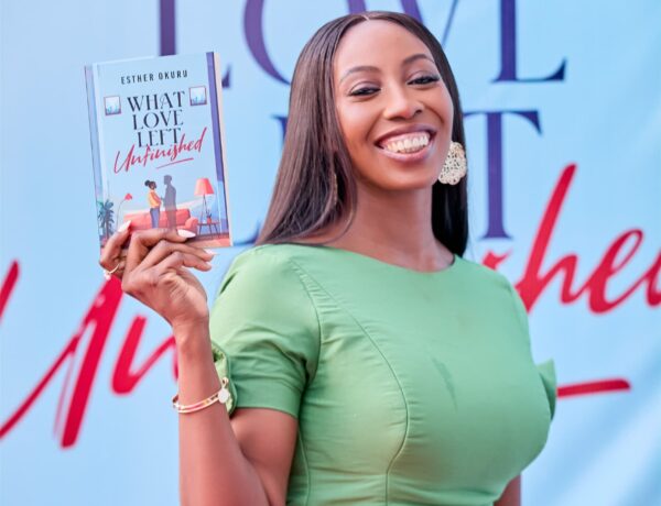 Woman smiling and holding a book